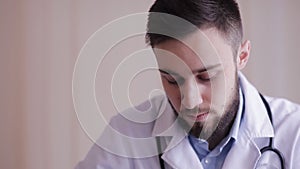 Close-up of a doctor, which makes palpation of the patient. Portrait of a doctor during the examination of the patient.