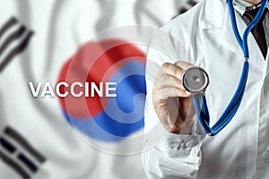 Close-up of a doctor and the word vaccine on the background of the flag of South Korea. Corona virus vaccine production. Pandemic