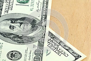 Close up 100 dollars banknotes on wooden background