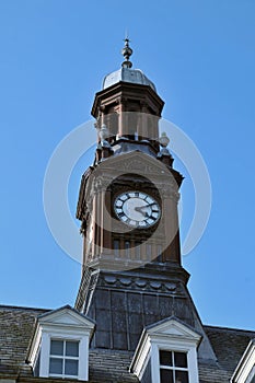 Close up of the dome and clock tower of leeds city hall in west yorkshire against a blue sky