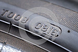 Close up of DOT number on tire which specify to week and year of product for determine the lifetime of the tire car on