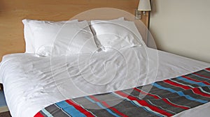 Close up of a double bed in an Hotel room.