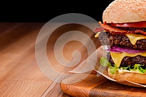 Close up on double cheeseburger on wooden background