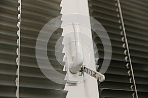 Close-up of double-glazed plastic window frame, one-way kitchen window handle, PVC window latch securing sash, metal