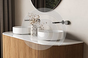 Close up of double sink with oval mirror standing in on beige wall , vanity with black faucet in minimalist bathroom.Side