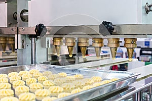 Close up dough or cream and nozzle discharge of automatic biscuit or sweets making machine in production line for high technology