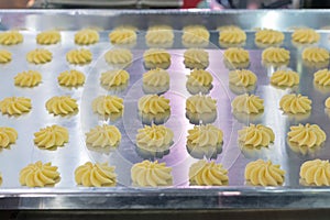 Close up dough or cream on tray of automatic biscuit or sweets making machine in production line for high technology of industrial