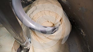 Close up for dough kneading on a bread bakery production factory. Stock footage. Bread Mixer In Bakery, mixing dough for