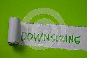Downsizing Text written in torn paper photo