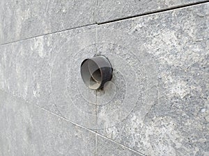 Close up of drainage water pipe. Waste-pipe on cement wall. Old stone wall with pipe for texture background. Construction and