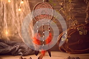 Close up of dream catcher on blurred background in evening sun light in vintage colors.