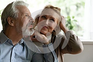 Close up dreamy mature spouses dreaming together, visualizing future