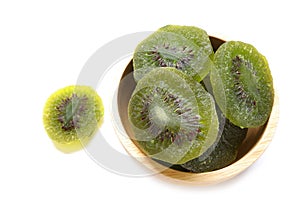 Close up of Dried dried kiwi fruit on wooden bowl isolated on white background.