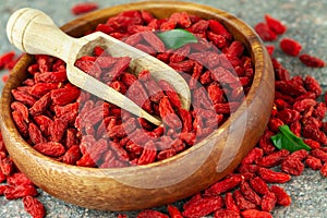 Close up of dried goji berries in wooden bowl. Selective focus