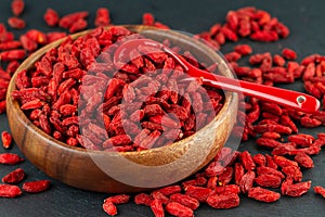 Close Up Of Dried Goji Berries In Wooden Cup. Selective Focus