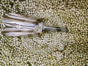 close up of dried green peas in a store by weight