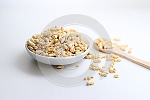 Close up of dried soy bean meat mince on white small plate with a wooden spoon