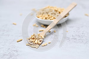 Close up of dried soy bean meat mince on wooden spoon