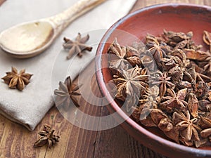 Close up of dried star anise in a wooden bowl