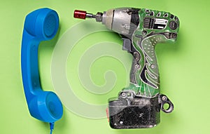 Close-up of drill and big blue telephone receiver