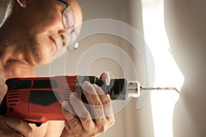 Close up drill, Old man using a drilling power tool