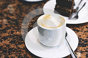 Close up drinking cup of hot aroma coffee isolated on the table in breakfast time, morning sun day, holiday relax concept