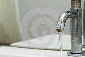 Close up of driping water drop or water leaking - save water con