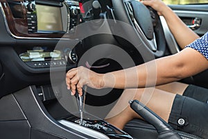 Close up driver left hand shifting the gear stick