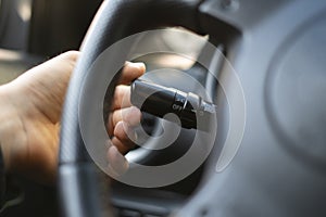 a close up driver shift turn signal on, car light set button