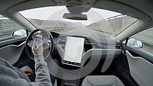 CLOSE UP: Driver texting in self-driving Tesla Model S autonomous automated car