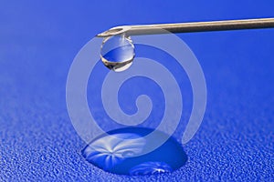 Close-up of a drop of medicine on the tip of a medical injection needle