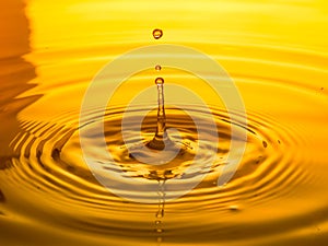 Close up of a drop oil on a yellow background