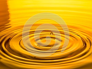 Close up of a drop oil on a yellow background