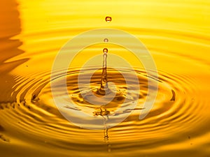 Close up of a drop oil on a yellow background