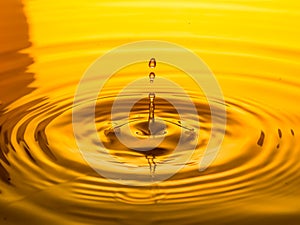 Close up of a drop oil on a yellow background