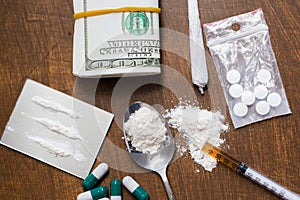 Close up of drugs, money, spoon and syringe