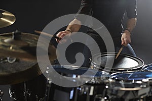 Close Up Of Drummer Playing Drum Kit In Studio photo