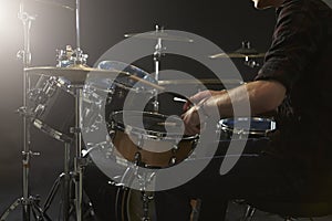 Close Up Of Drummer Playing Drum Kit In Studio photo