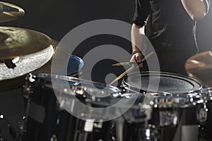 Close Up Of Drummer Playing Drum Kit In Studio