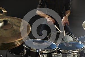 Close Up Of Drummer Playing Snare Drum On Kit In Studio photo