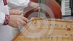 Close up of dulcimer string and wooden bat