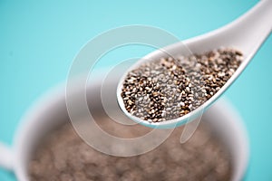 Close-up of ealthy chia seeds in a spoon. Text space.