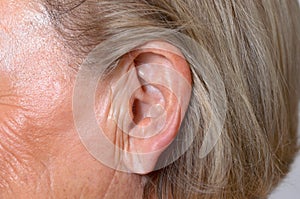 Close up of the ear of an elderly woman photo