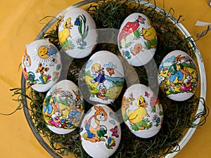 Close up on easter eggs on a yellow tablecloth with copy space