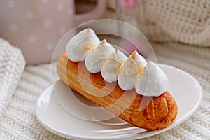 Close Up of eclair on a white plate.