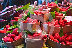 Close up. Eco-friendly cardboard boxes with strawberries for tourists at a Spanish market