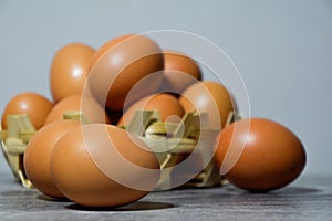 Close up of egg - Many eggs in a small bamboo basket on the gray wooden floor, Chicken eggs contain protein and many other