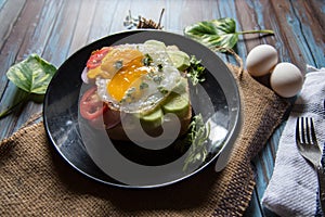 Close up of egg poach, salad condiments on bun bread