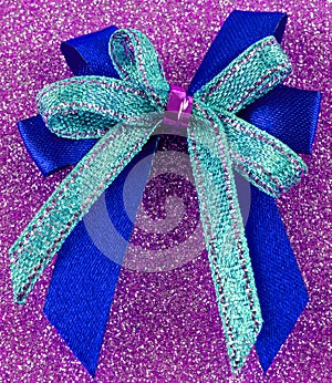 Pretty double gift bow on a sparkly surface. photo