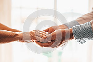 Close up elderly affectionate woman covering wrinkled hands of mature husband, showing love and support at home. Caring middle